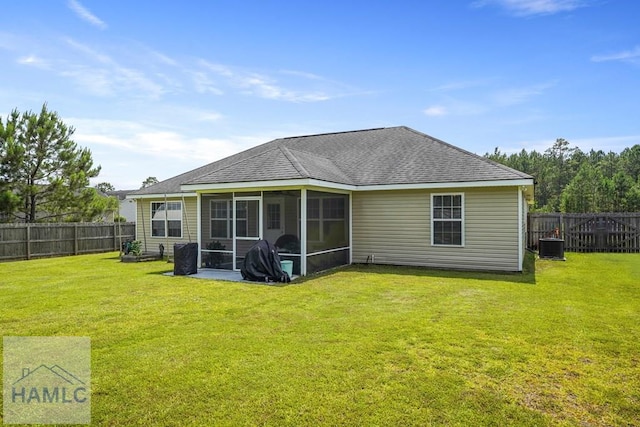 138 Forest St NE, Ludowici, GA 31316 - back of property featuring a sunroom, a fenced backyard, and roof with shingles