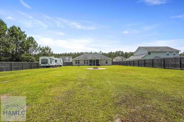 138 Forest St NE, Ludowici, GA 31316 - fenced backyard with a fire pit