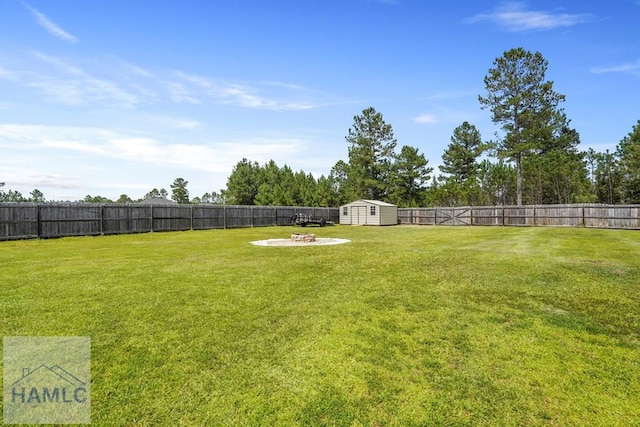 138 Forest St NE, Ludowici, GA 31316 - fenced backyard featuring a storage unit and a fire pit