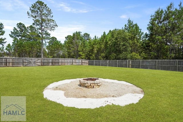 138 Forest St NE, Ludowici, GA 31316 - fenced backyard featuring an outdoor fire pit