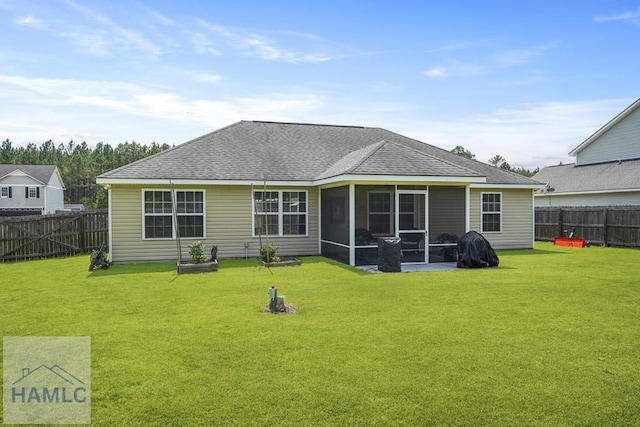 138 Forest St NE, Ludowici, GA 31316 - back of property with a fenced backyard, a sunroom, and a shingled roof