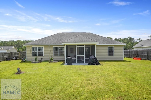 138 Forest St NE, Ludowici, GA 31316 - back of house featuring roof with shingles, a fenced backyard, and a sunroom