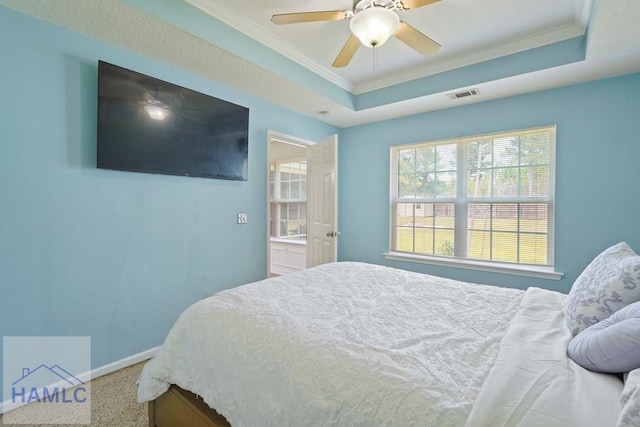138 Forest St NE, Ludowici, GA 31316 - bedroom with ornamental molding, a tray ceiling, carpet, and a ceiling fan