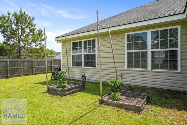 138 Forest St NE, Ludowici, GA 31316 - view of side of property with a garden and roof with shingles