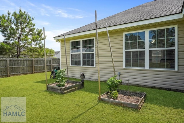 138 Forest St NE, Ludowici, GA 31316 - view of side of property with a vegetable garden and roof with shingles