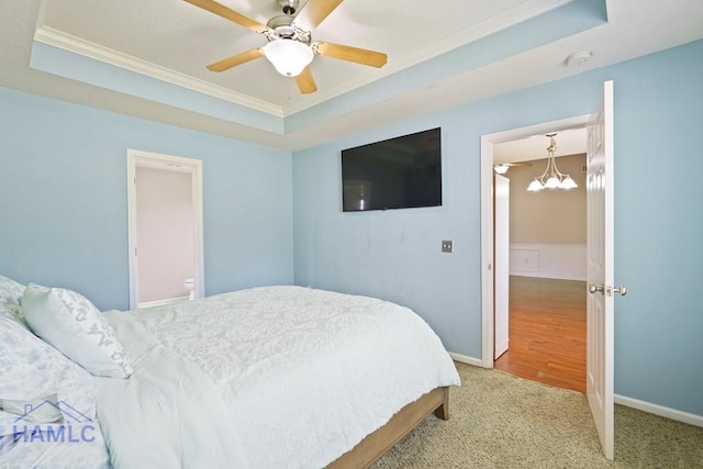138 Forest St NE, Ludowici, GA 31316 - bedroom with a raised ceiling, carpet flooring, crown molding, a ceiling fan, and a chandelier