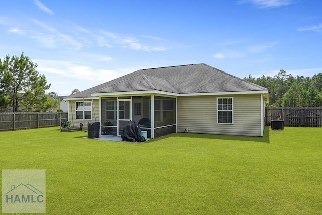138 Forest St NE, Ludowici, GA 31316 - back of property featuring a sunroom, a fenced backyard, and a shingled roof