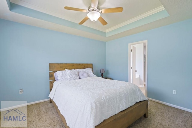 138 Forest St NE, Ludowici, GA 31316 - bedroom featuring a raised ceiling, ornamental molding, carpet floors, ceiling fan, and ensuite bath