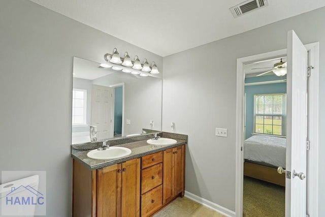 138 Forest St NE, Ludowici, GA 31316 - ensuite bathroom featuring double vanity and ceiling fan