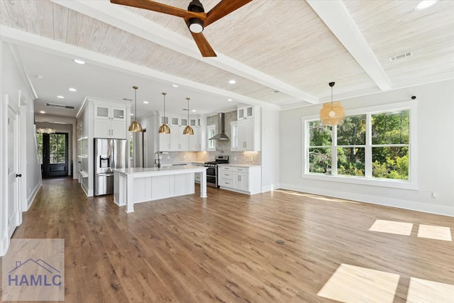 unfurnished living room with wood ceiling, beamed ceiling, baseboards, recessed lighting, and wood finished floors