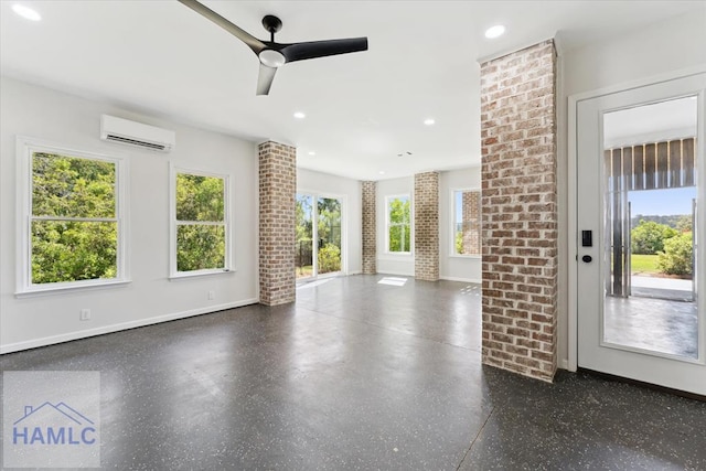 unfurnished living room featuring recessed lighting, a wall mounted AC, ceiling fan, baseboards, and speckled floor