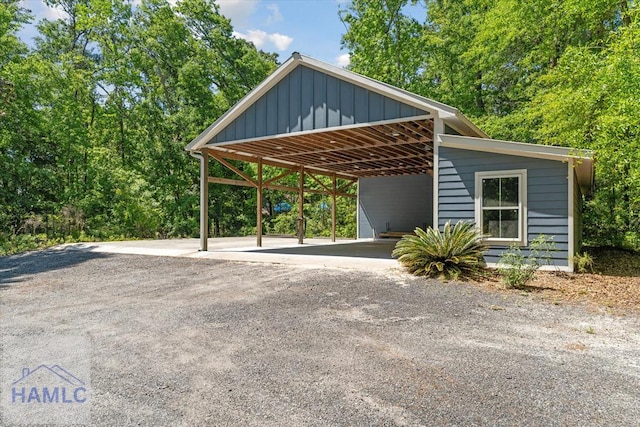 view of parking featuring aphalt driveway and a carport
