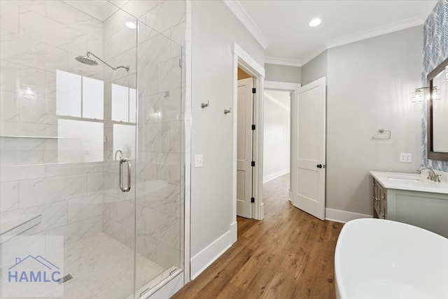 bathroom with wood finished floors, a stall shower, and baseboards