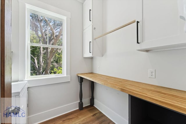 interior space featuring dark wood-style floors and baseboards