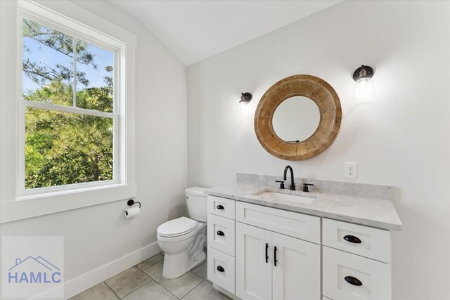 1018 Sweet Hill Rd, Richmond Hill, GA 31324 - half bathroom featuring lofted ceiling, tile patterned floors, toilet, baseboards, and vanity
