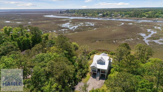 birds eye view of property with a water view and a view of trees