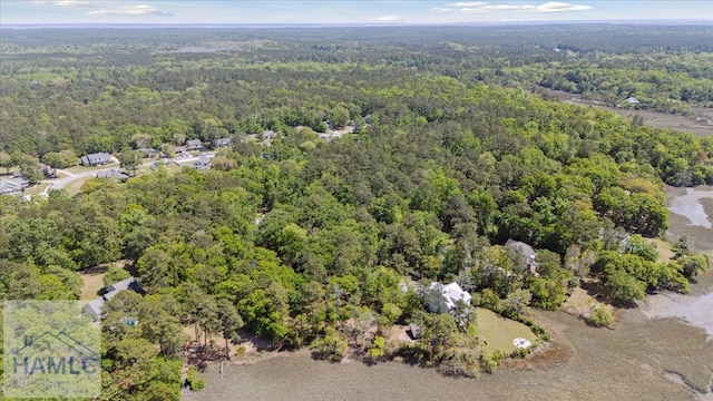 drone / aerial view with a wooded view