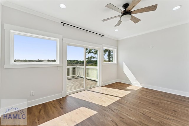 unfurnished room with baseboards, recessed lighting, wood finished floors, and a ceiling fan