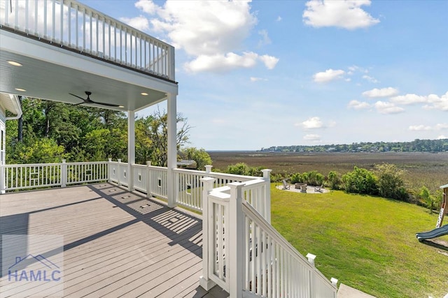 deck featuring a lawn and ceiling fan