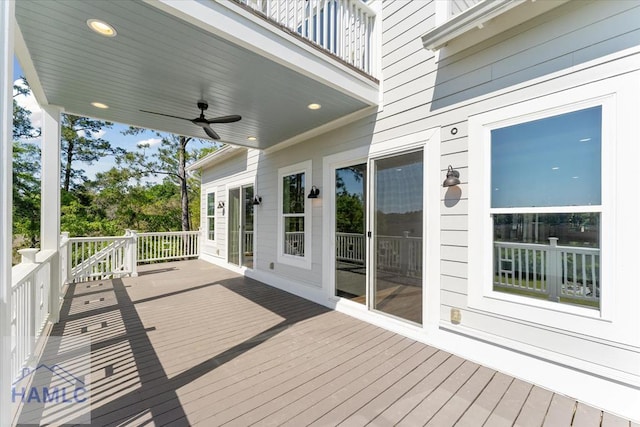 wooden deck with a ceiling fan