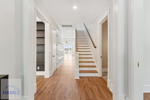 interior space featuring baseboards, recessed lighting, wood finished floors, and visible vents