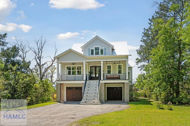 1018 Sweet Hill Rd, Richmond Hill, GA 31324 - view of front of home with stairway, ceiling fan, french doors, a front lawn, and driveway
