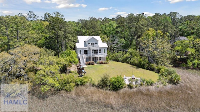 drone / aerial view featuring a wooded view