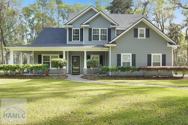 view of front of home featuring a front yard, a porch, and a shingled roof