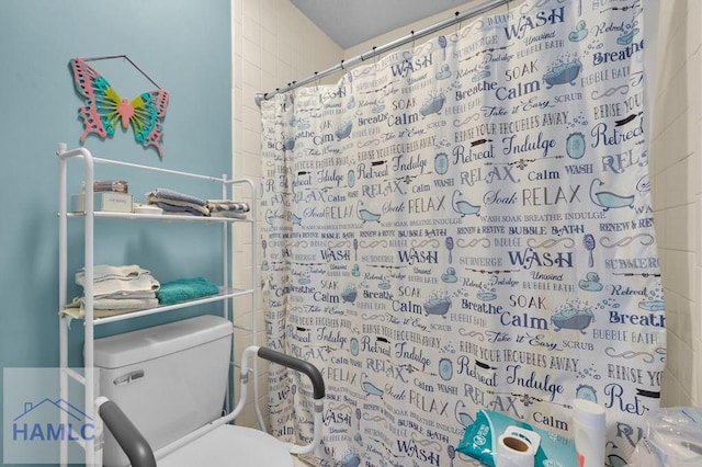 bathroom featuring toilet and walk in shower