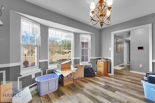 interior space featuring hardwood / wood-style floors and a chandelier