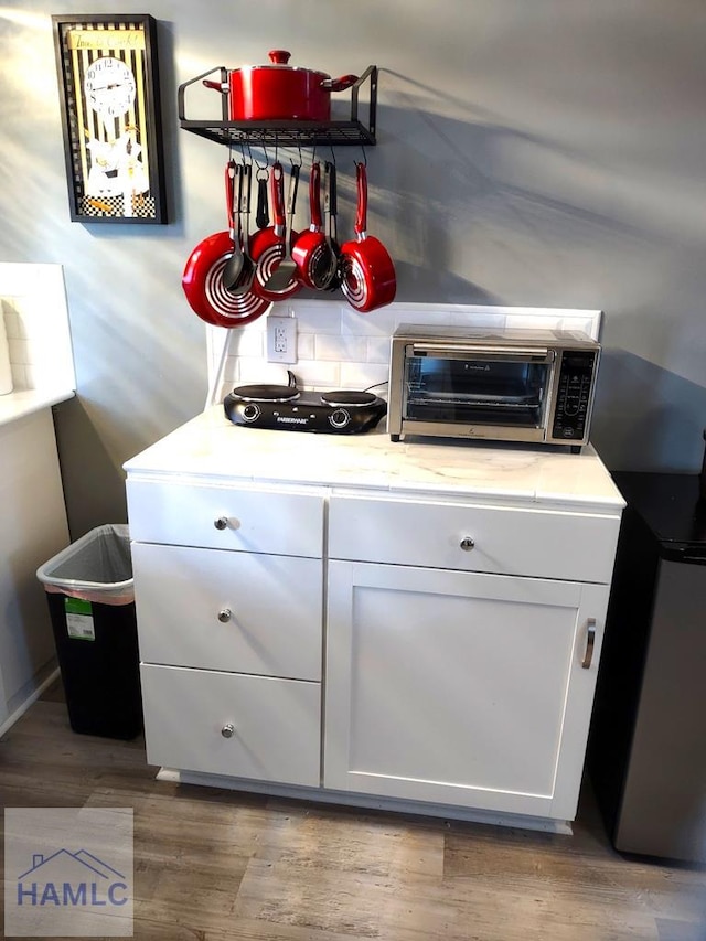 interior space featuring white cabinets and wood-type flooring