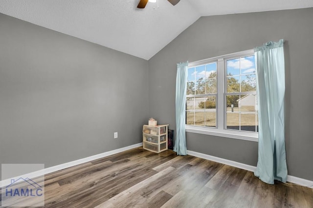 unfurnished room featuring lofted ceiling, ceiling fan, and wood-type flooring