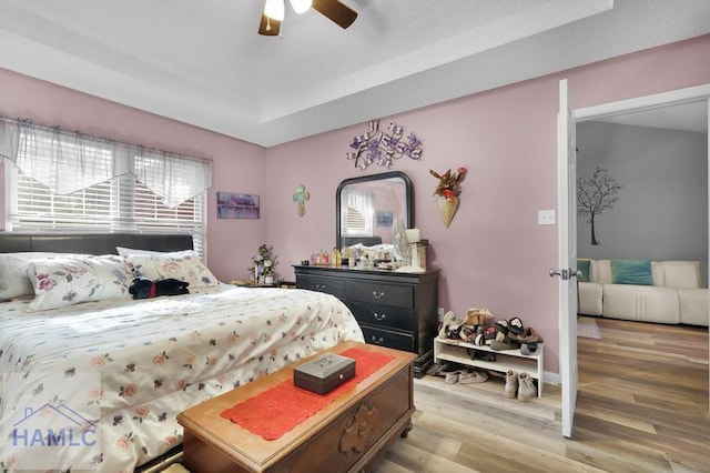 bedroom with light wood-type flooring and ceiling fan