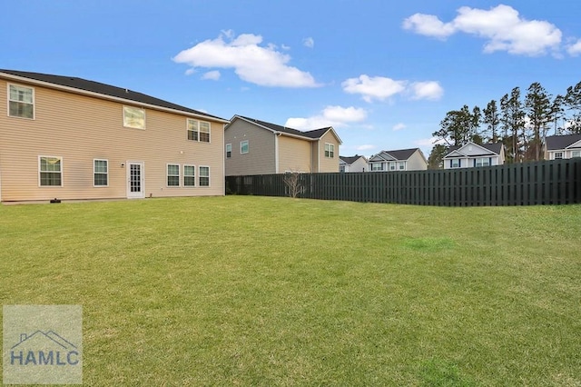 view of yard featuring fence and a residential view