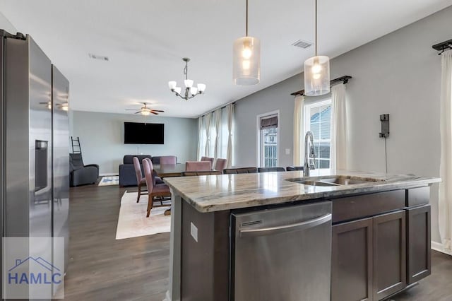 kitchen with dark wood-type flooring, visible vents, stainless steel appliances, and a sink