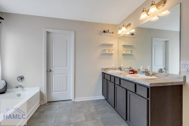 full bathroom with double vanity, a garden tub, tile patterned flooring, and a sink