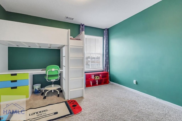 carpeted office with visible vents and baseboards