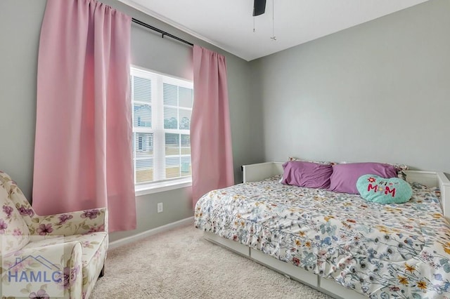 carpeted bedroom featuring baseboards and ceiling fan
