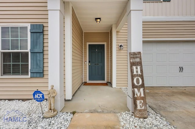 view of exterior entry with a garage
