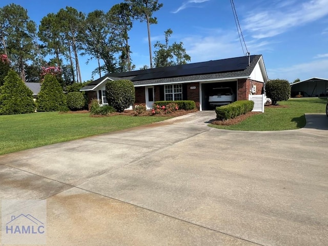 3520 Waycross Hwy, Jesup, GA 31545 - view of front facade with a garage, brick siding, a front yard, and solar panels