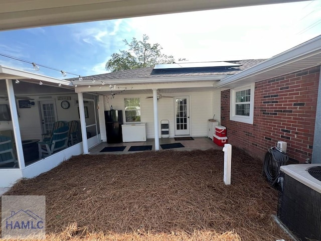 3520 Waycross Hwy, Jesup, GA 31545 - entrance to property featuring roof mounted solar panels, brick siding, a shingled roof, and ceiling fan