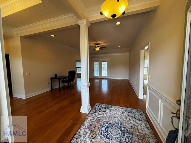 interior space with crown molding, decorative columns, and dark wood finished floors