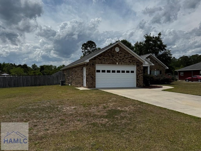 view of side of property with brick siding, fence, a yard, an attached garage, and concrete driveway
