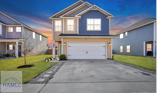 view of front of house featuring a lawn and a garage