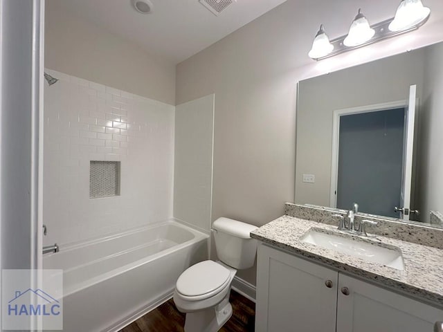 full bathroom with hardwood / wood-style flooring, vanity, toilet, and shower / washtub combination