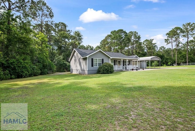 96 Palm Tree Pl, Jesup, GA 31545 - view of front facade with covered porch, a carport, and a front lawn
