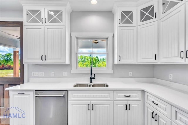 kitchen featuring a sink, stainless steel dishwasher, healthy amount of natural light, white cabinetry, and recessed lighting