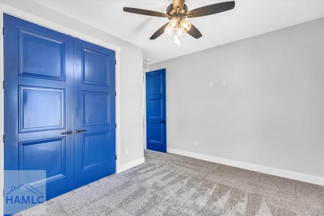 unfurnished bedroom with carpet flooring, baseboards, ceiling fan, and a closet
