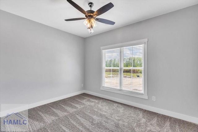 carpeted spare room with baseboards and ceiling fan