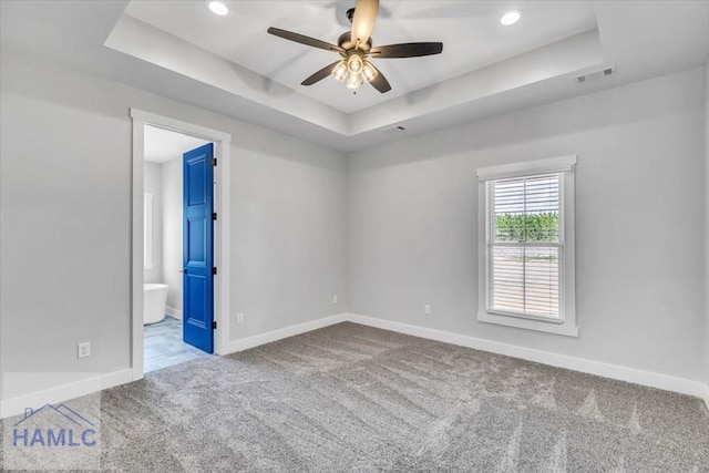 carpeted empty room with a raised ceiling, baseboards, a ceiling fan, and recessed lighting